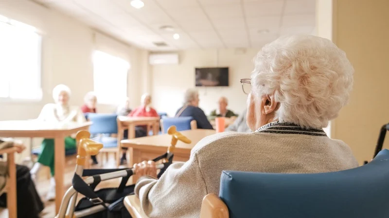 Elderly-woman-using-walker-inside-a-nursing-home-during-summer-heatwave How Nursing Homes Can Safeguard Vulnerable Residents During Summer