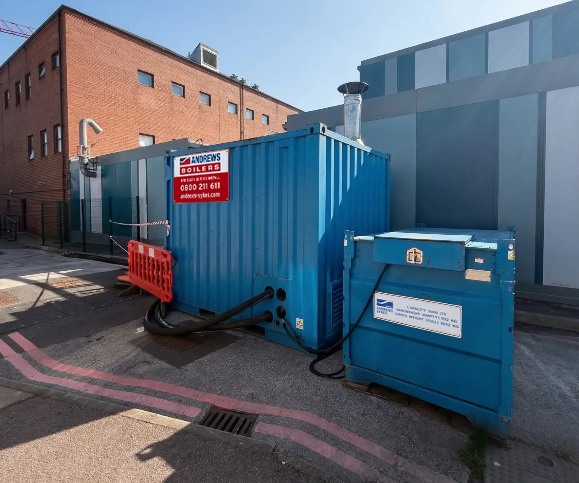 Temporary boiler and fuel tank is beside an education building Packaged temporary boiler and bunded fuel tank sited beside a facility to maintain heating systems